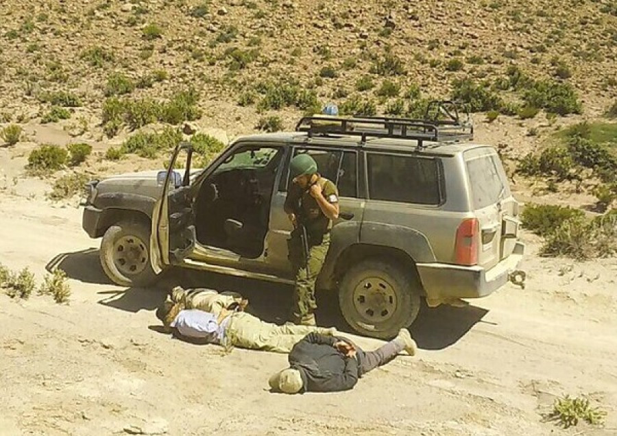 Funcionarios bolivianos bajo custodia de un carabinero de Chile. Foto: Agencia Boliviana de Información  El Deber.