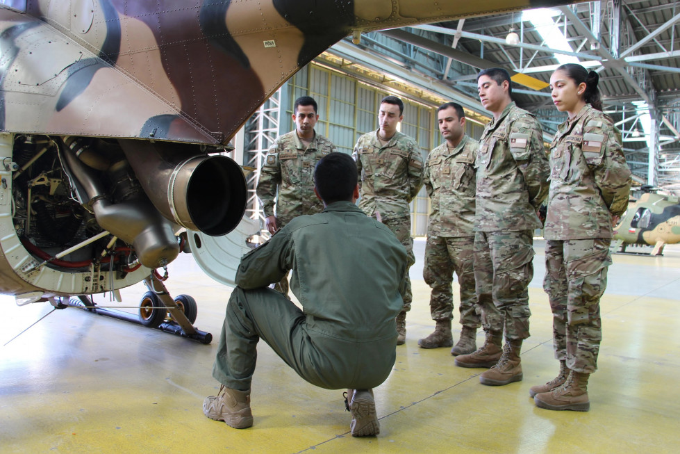 Los oficiales alumnos del Curso de Piloto 2024 junto a un helicóptero MD 530F de la Bave Firma Ejército de Chile